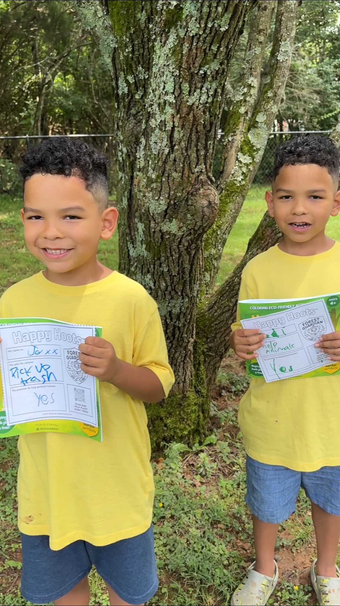 Two kids with their Forest Guardian certificates