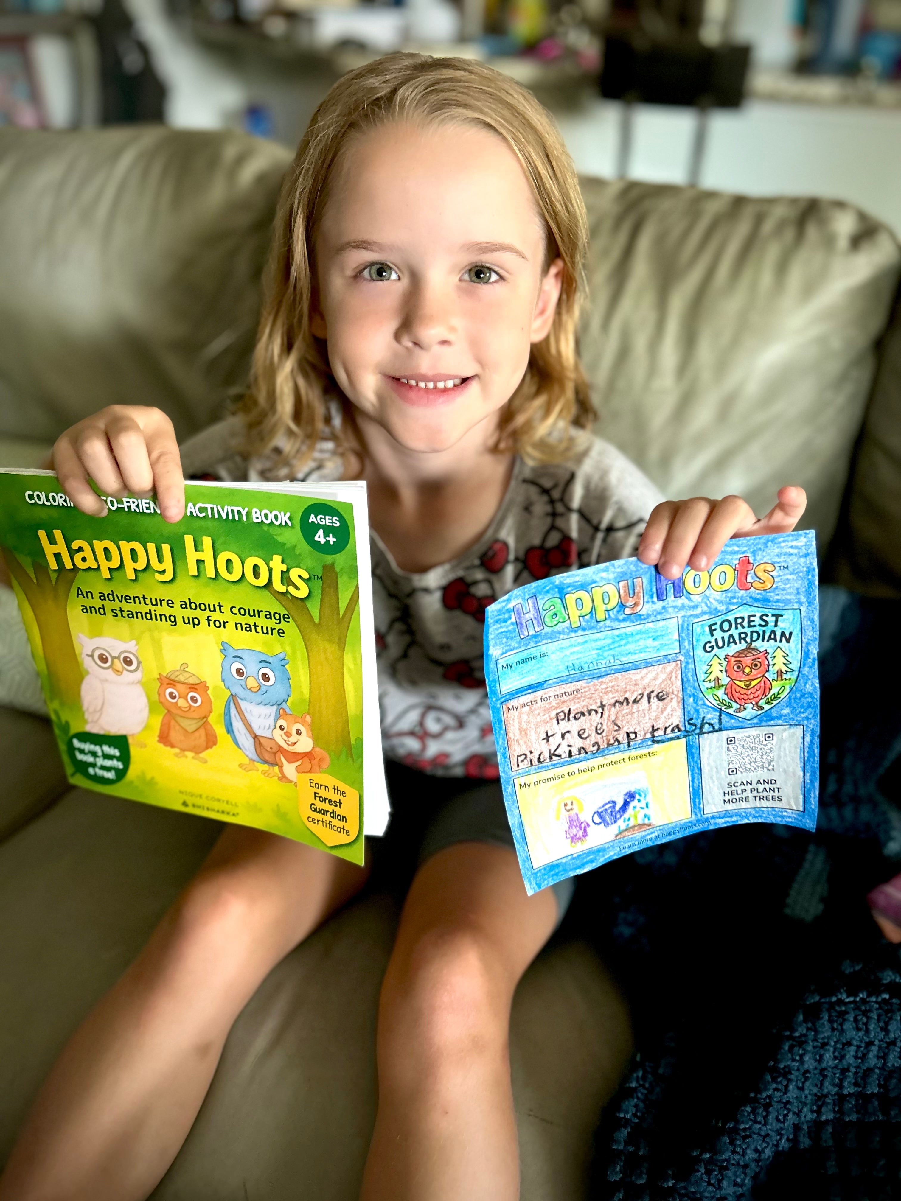 A young reader with her Happy Hoots book
