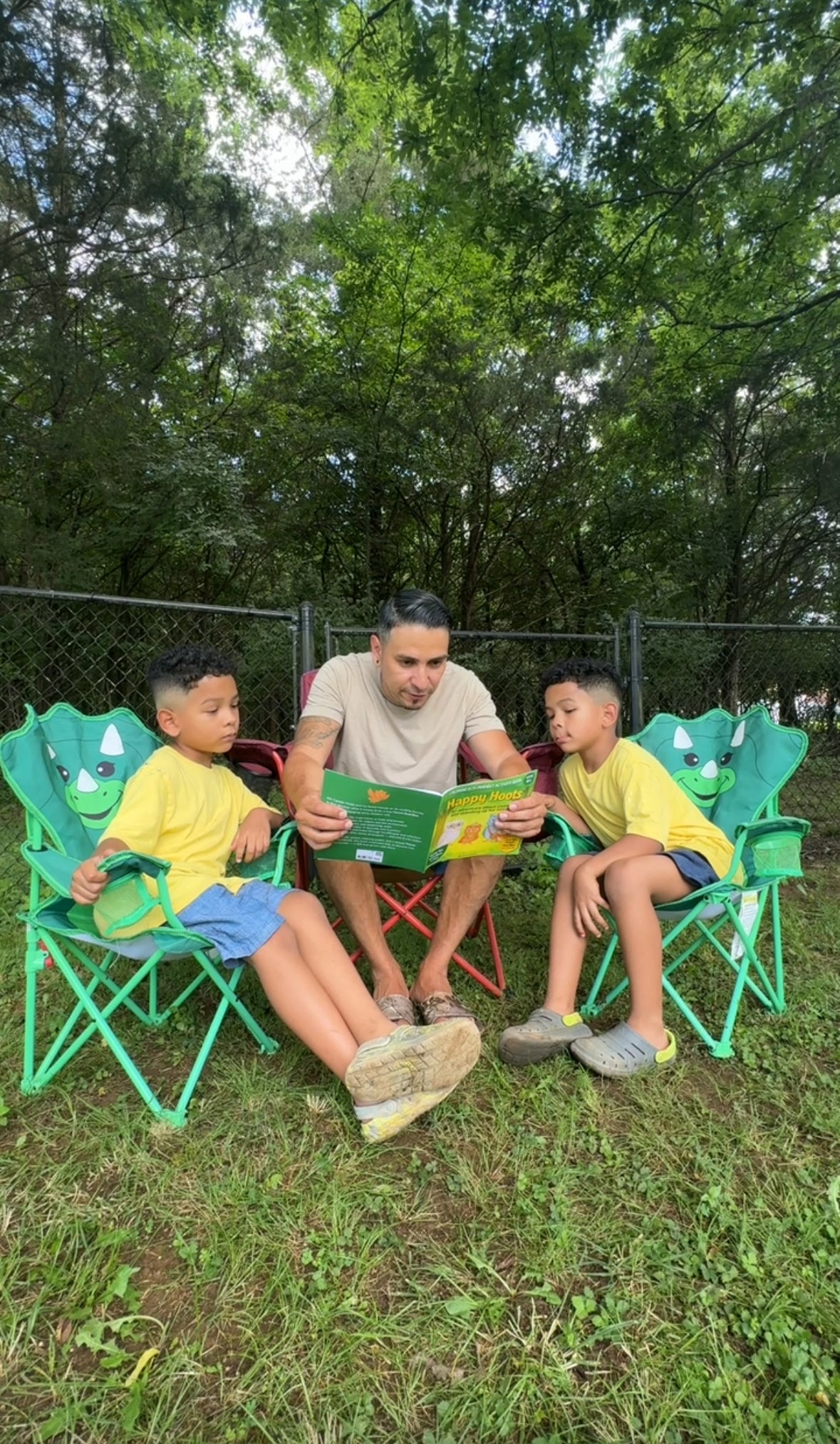 A dad reading Happy Hoots with his two sons